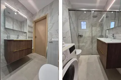 a bathroom with a washing machine and a shower at Athens Riviera Alimos by Comfort Club in Athens