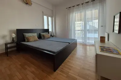 a bedroom with a bed and a large window at Athens Riviera Alimos by Comfort Club in Athens