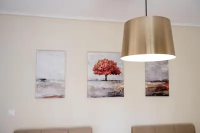 two paintings of a tree on a wall at Athens Unity Apartment in Athens