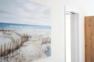 a painting of a beach view from a window at Athens Unity Apartment in Athens