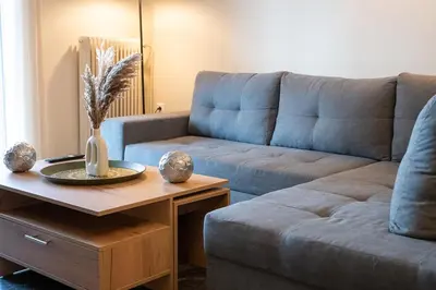 a living room with a couch and a table at Athens Unity Apartment in Athens