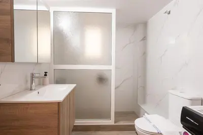 a bathroom with a shower and a sink and a toilet at Athens Unity Apartment in Athens