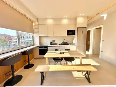 a small kitchen with a wooden table and chairs at Boutique City Apartment 3' Metro in Athens