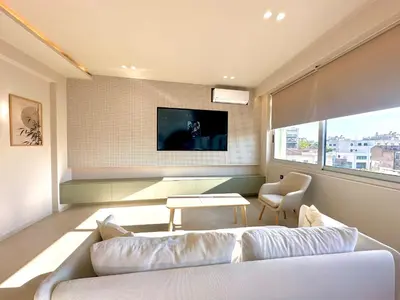 a living room with a white couch and a tv at Boutique City Apartment 3' Metro in Athens