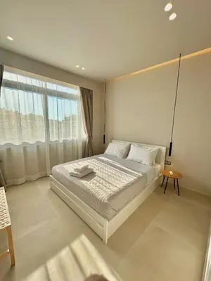 a white bedroom with a large bed and a window at Boutique City Apartment 3' Metro in Athens