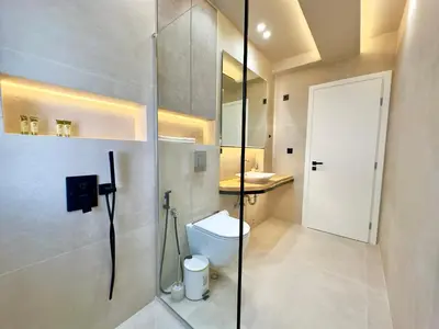 a bathroom with a toilet and a glass shower door at Boutique City Apartment 3' Metro in Athens