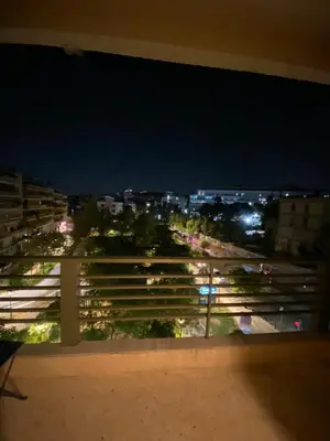 a view of a city at night from a balcony at Elegant Flat Near Hospitals & Museums in Athens