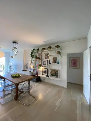a dining room with a wooden table and a dining roomiasm at Elegant Flat Near Hospitals & Museums in Athens