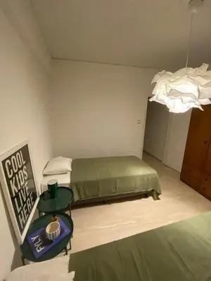 a bedroom with a bed and a table in it at Elegant Flat Near Hospitals & Museums in Athens