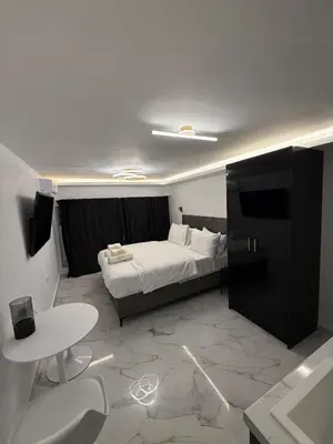 a bedroom with a bed and a desk and a table at City Center Lux Studio in Athens