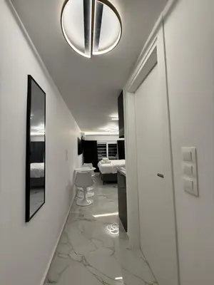 a hallway with a room with a bed and a chandelier at City Center Lux Studio in Athens