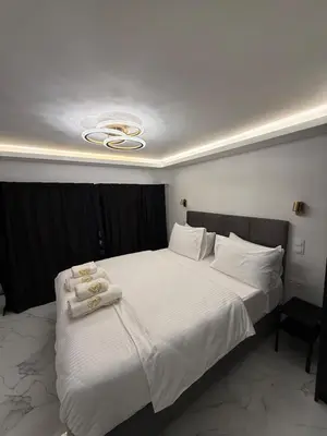 a bedroom with a large bed with towels on it at City Center Lux Studio in Athens