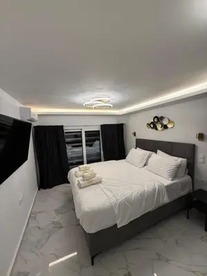 a bedroom with a large bed with white sheets at City Center Lux Studio in Athens