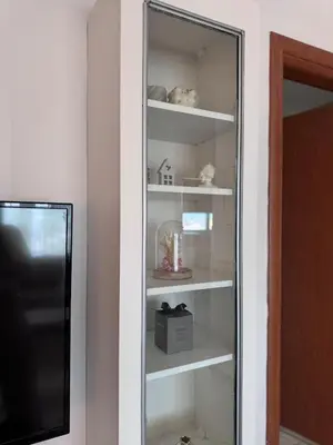 a glass shelf in a room with a refrigerator at Parmen APT in Piraeus