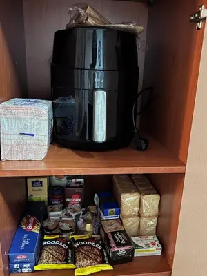 a coffee maker sitting on top of a shelf with food at Parmen APT in Piraeus