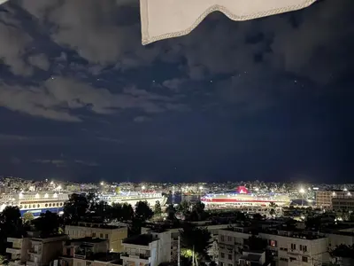 a view of a city at night at Parmen APT in Piraeus