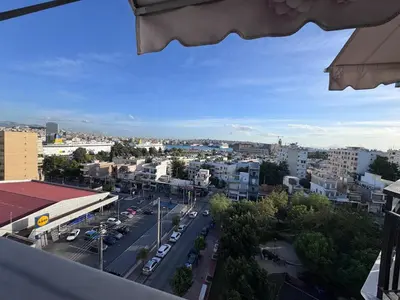 a view of a city with a street and buildings at Parmen APT in Piraeus