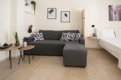 a living room with a couch and a bed at ANDIE Kallithea Filaretou in Athens
