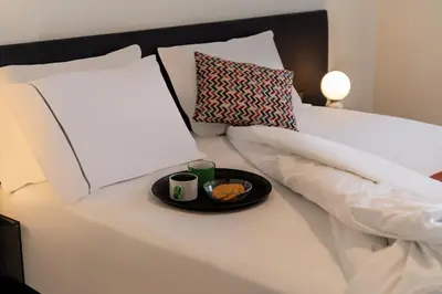 a white bed with a tray of food on it at Mia Homes - Athens Riviera at Voula Center in Athens