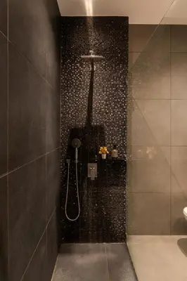 a bathroom with a shower with black tiles at Mia Homes - Athens Riviera at Voula Center in Athens