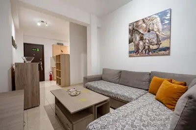 a living room with a couch and a table at City Base for 2 - Kolonos near Metro by ΜΡS in Athens