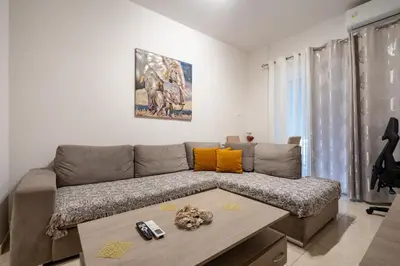 a living room with a couch and a table at City Base for 2 - Kolonos near Metro by ΜΡS in Athens