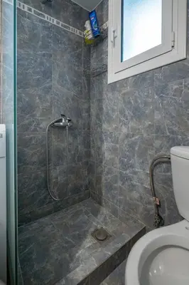 a bathroom with a shower and a toilet at City Base for 2 - Kolonos near Metro by ΜΡS in Athens