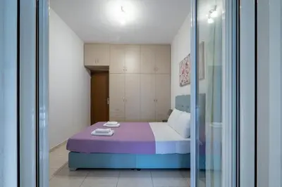 a small bedroom with a purple bed in a room at City Base for 2 - Kolonos near Metro by ΜΡS in Athens