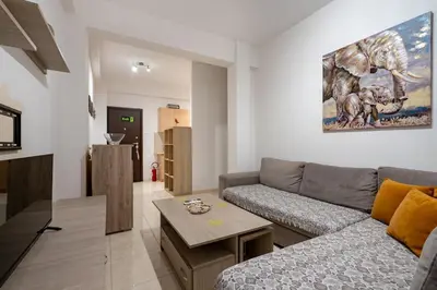 a living room with a couch and a table at City Base for 2 - Kolonos near Metro by ΜΡS in Athens
