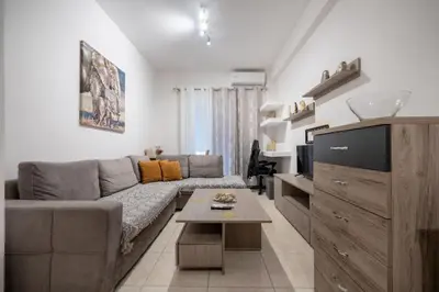 a living room with a couch and a table at City Base for 2 - Kolonos near Metro by ΜΡS in Athens