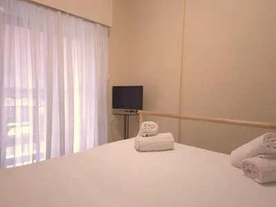 a bedroom with a bed with towels on it at The Cozy Blue Flat in Athens