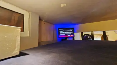a room with a tv and a room with blue lights at Cozy Smart studio apartment in Athens in Athens