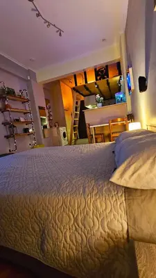 a bedroom with a large bed and a kitchen at Cozy Smart studio apartment in Athens in Athens