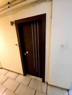 a brown door in a room with a tile floor at Cozy Smart studio apartment in Athens in Athens