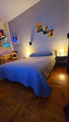 a bedroom with a bed with a blue comforter at Cozy Smart studio apartment in Athens in Athens