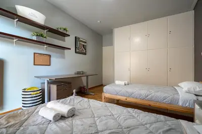 a bedroom with two beds and a desk in it at Petralona 2BDRM -Easy Access to City Center by ΜΡS in Athens