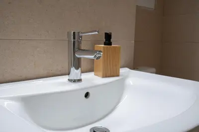 a bathroom sink with a soap dispenser on it at Petralona 2BDRM -Easy Access to City Center by ΜΡS in Athens