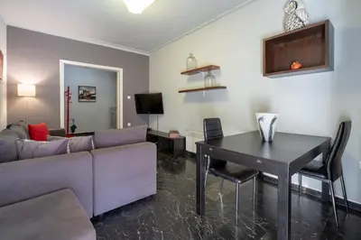 a living room with a couch and a table at Petralona 2BDRM -Easy Access to City Center by ΜΡS in Athens