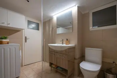 a bathroom with a white toilet and a sink at Petralona 2BDRM -Easy Access to City Center by ΜΡS in Athens