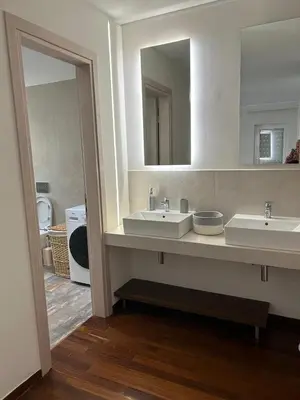 a bathroom with two sinks and a large mirror at Glyfada Top-Floor 2BR, Sea and City Views in Athens