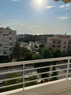 a view of a city from a balcony at Glyfada Top-Floor 2BR, Sea and City Views in Athens