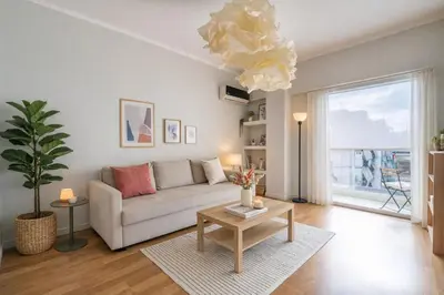a living room with a couch and a table at Urban Grace - In the Heart of Athens in Athens