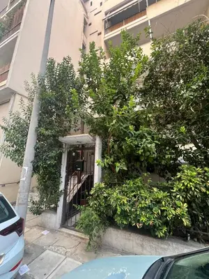 a building with trees on the side of it at Athenian Maisonette near Metro & shops in Athens