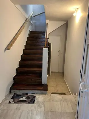 a staircase in a house with a wooden floor at Athenian Maisonette near Metro & shops in Athens