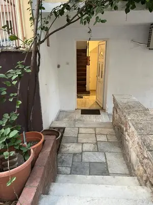 a hallway of a house with a door and plants at Athenian Maisonette near Metro & shops in Athens
