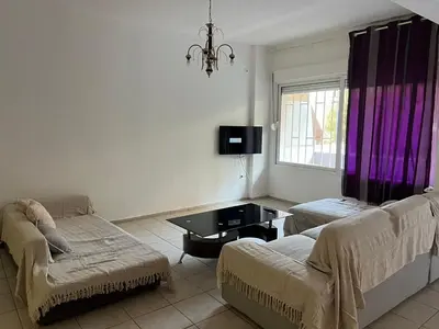 a living room with a couch and a table at Athenian Maisonette near Metro & shops in Athens
