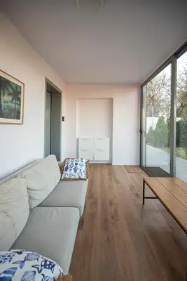 a living room with a white couch and a table at Villa Tata - Private Pool, Garden & Mountain View near the Sea in Metókhi
