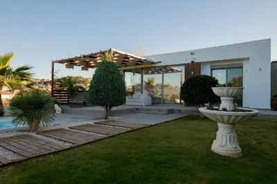a house with a garden with a fountain in the yard at Villa Tata - Private Pool, Garden & Mountain View near the Sea in Metókhi