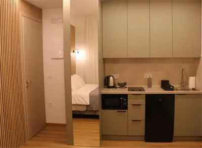a small kitchen with a sink and a bed at FaliroRelax F1 in Athens
