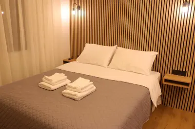 a bedroom with a bed with towels on it at FaliroRelax F1 in Athens